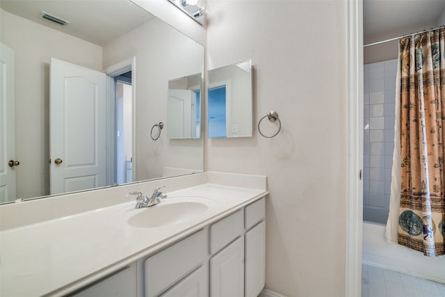 bathroom featuring vanity and shower / bath combo with shower curtain