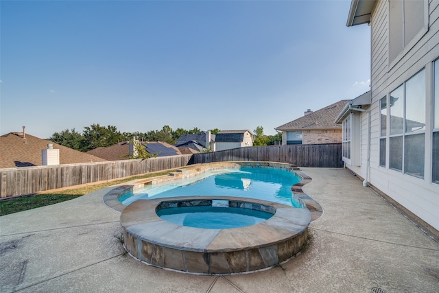 view of pool featuring a patio area and an in ground hot tub