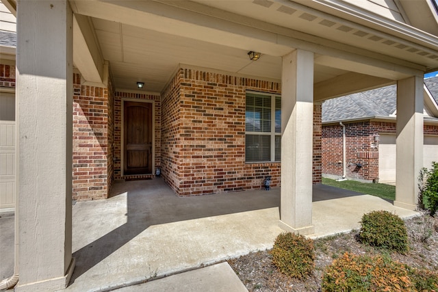 view of exterior entry featuring a porch