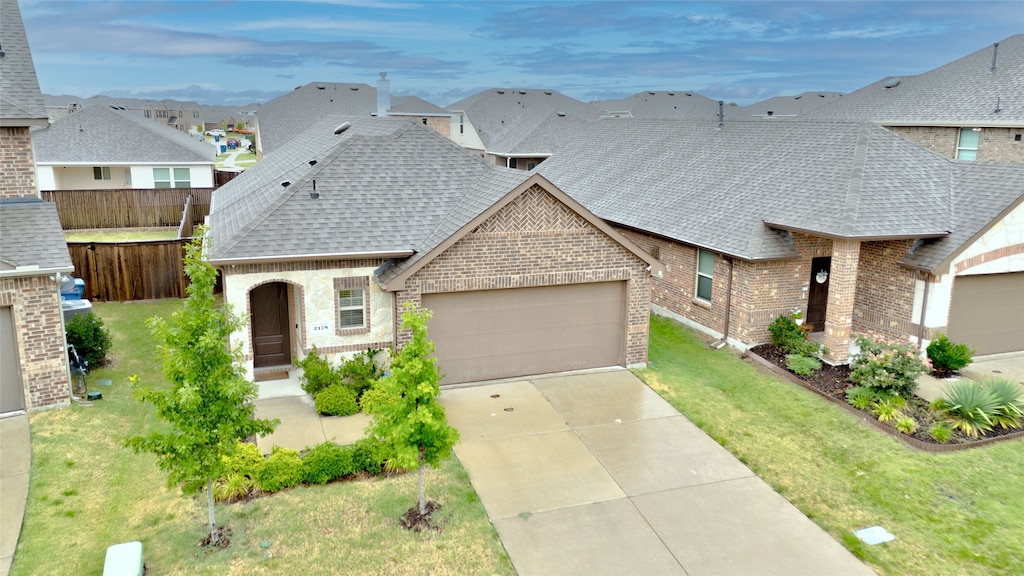 view of front facade featuring a front yard and a garage