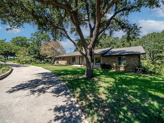 ranch-style house with a front lawn