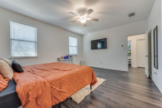 bedroom with dark hardwood / wood-style floors and ceiling fan