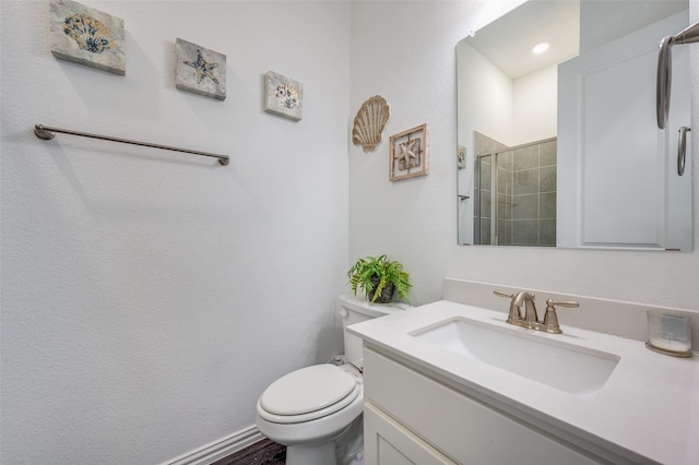 bathroom with vanity, an enclosed shower, and toilet