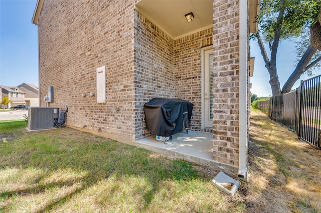 exterior space featuring a yard, cooling unit, and a patio area