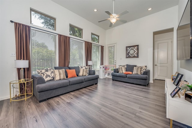 living room featuring ceiling fan and light wood-type flooring