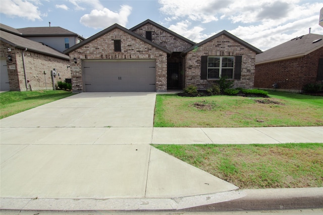 view of front of home with a front lawn and a garage