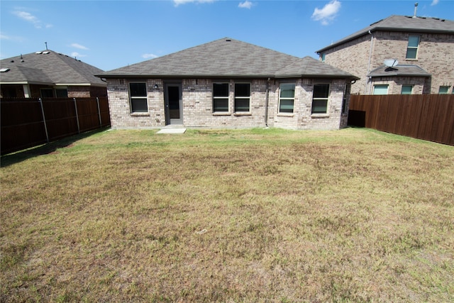 rear view of house with a yard