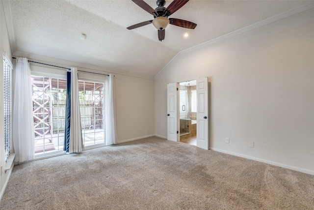 spare room with vaulted ceiling, light colored carpet, ceiling fan, and a textured ceiling