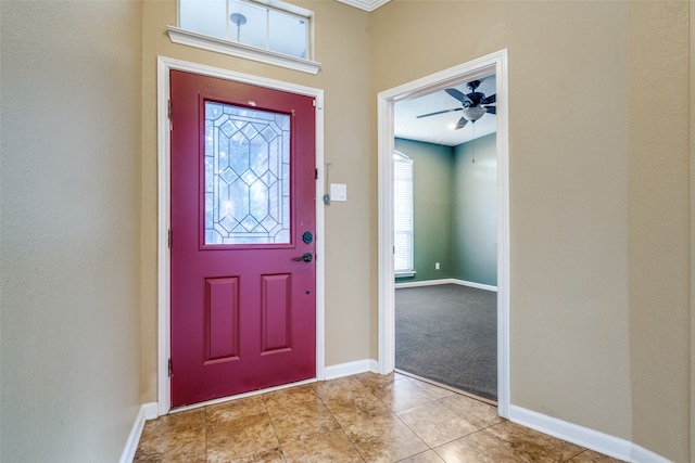 foyer entrance with ceiling fan and light tile patterned floors