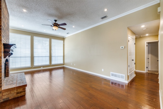 unfurnished living room with ceiling fan, a fireplace, dark hardwood / wood-style floors, and a textured ceiling