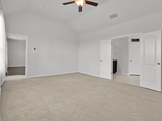 carpeted empty room with ceiling fan and vaulted ceiling