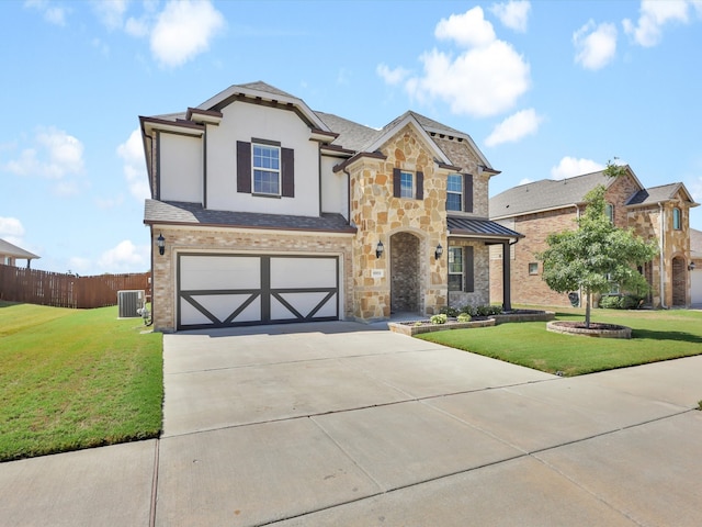 view of front of property with a garage, central AC unit, and a front lawn