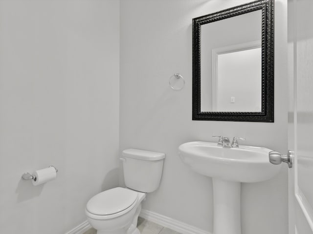 bathroom with tile patterned flooring and toilet