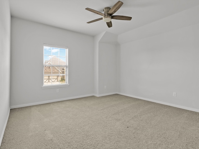 carpeted spare room featuring ceiling fan