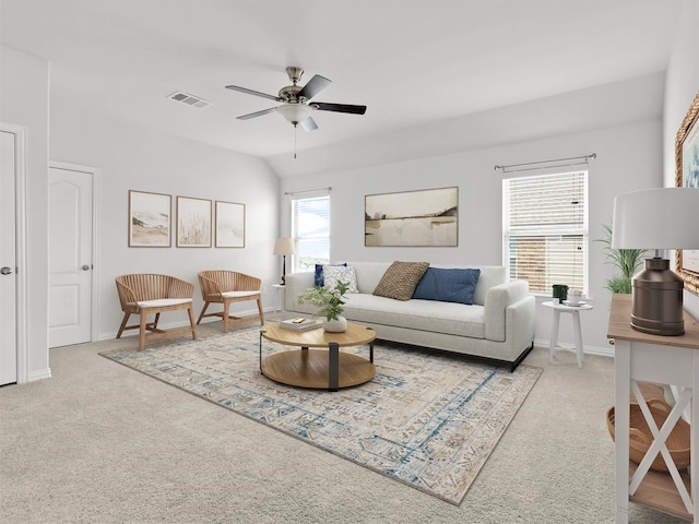 carpeted living room with ceiling fan