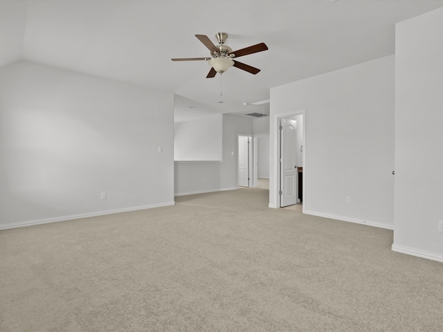 carpeted empty room featuring vaulted ceiling and ceiling fan