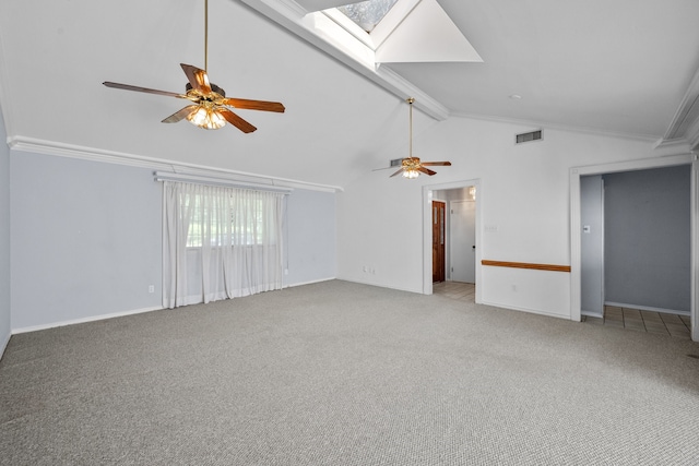 unfurnished room featuring ceiling fan, crown molding, a skylight, beam ceiling, and light colored carpet