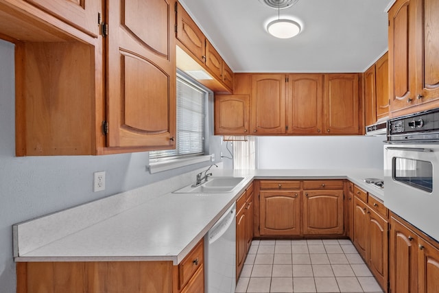 kitchen with light tile patterned flooring, gas cooktop, oven, sink, and stainless steel dishwasher