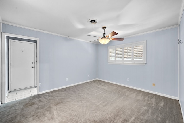 empty room with light carpet, crown molding, and ceiling fan