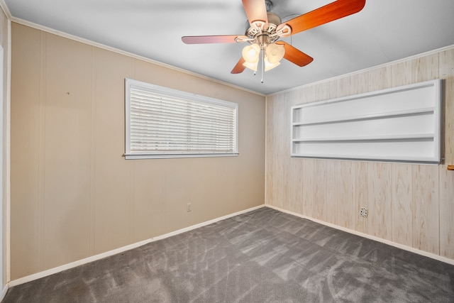 carpeted spare room featuring built in features, crown molding, and ceiling fan