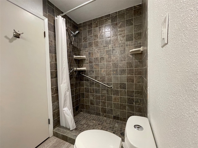 bathroom with hardwood / wood-style flooring, toilet, and a shower with shower curtain