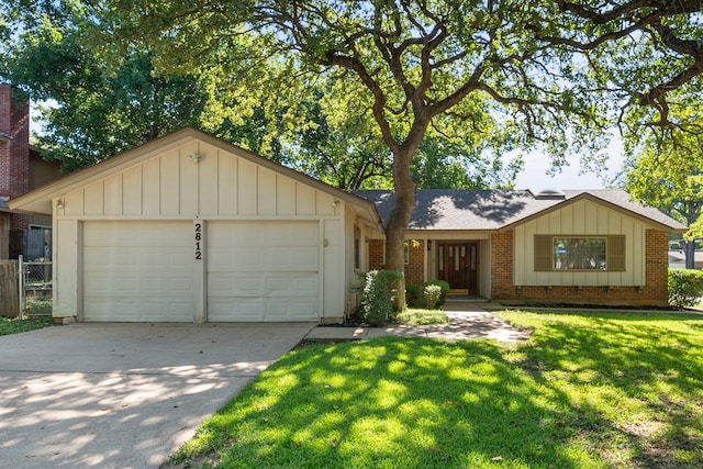 single story home with a garage and a front lawn