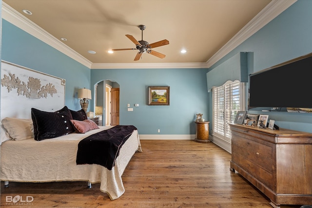 bedroom with ornamental molding, ceiling fan, and hardwood / wood-style flooring