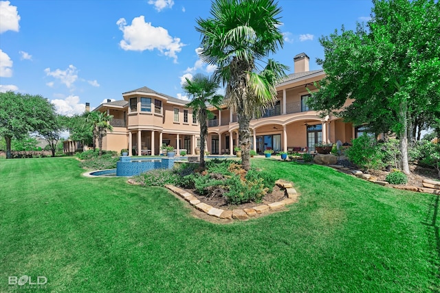 rear view of house featuring a lawn and a patio area