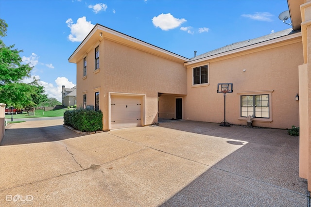 view of side of home featuring a garage