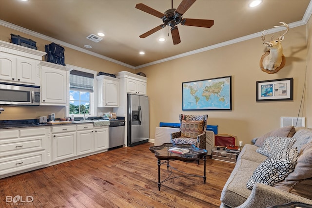 kitchen with ceiling fan, white cabinets, stainless steel appliances, and dark hardwood / wood-style floors