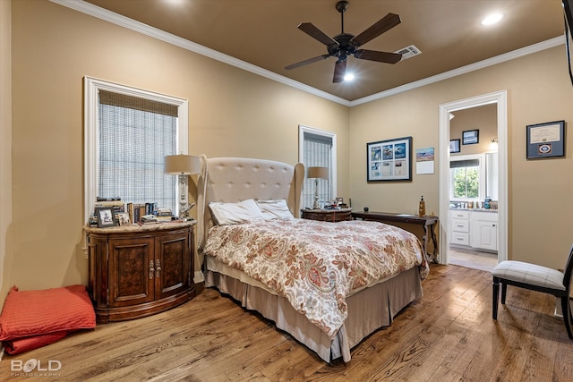 bedroom with ornamental molding, ceiling fan, hardwood / wood-style flooring, and ensuite bathroom