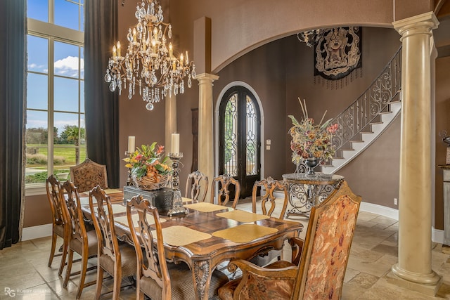 dining space with french doors, a notable chandelier, and a high ceiling