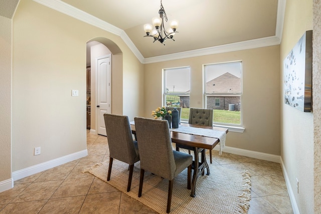 dining room with ornamental molding, light tile patterned floors, and a notable chandelier