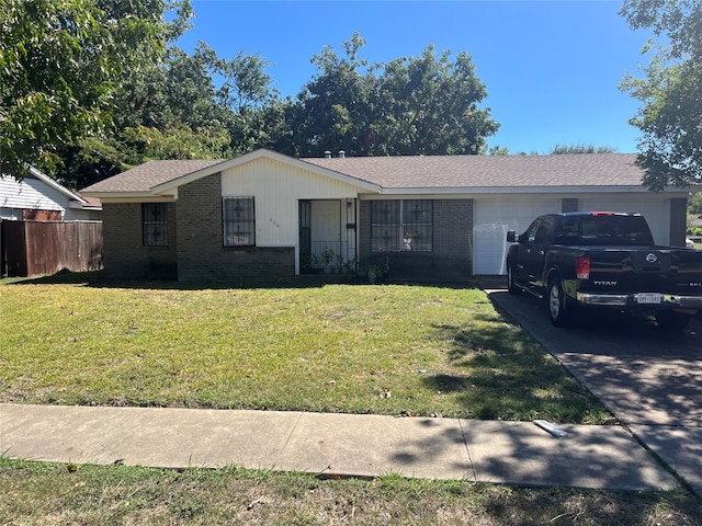 single story home featuring a garage and a front yard