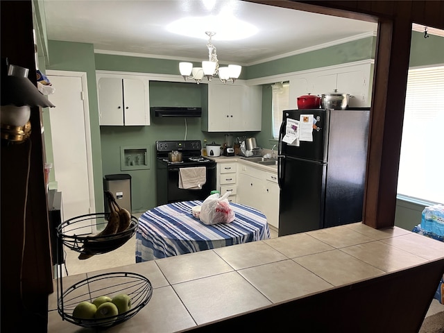 kitchen featuring white cabinets, black appliances, and tile counters