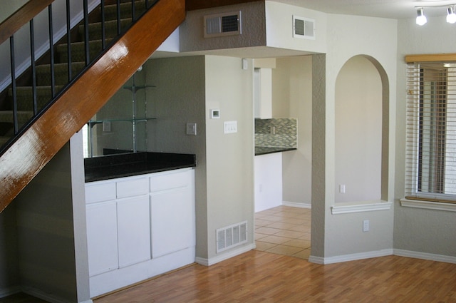 interior space featuring wood-type flooring and decorative backsplash