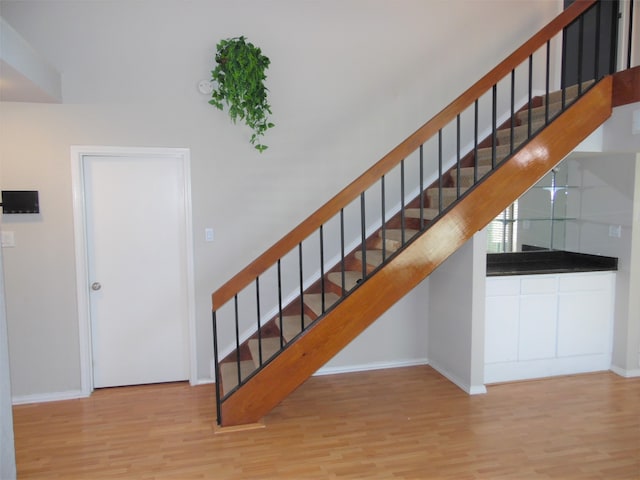 stairway with hardwood / wood-style flooring