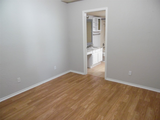 empty room featuring light hardwood / wood-style flooring and sink