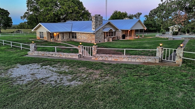 view of front of house with a yard and a fenced in pool