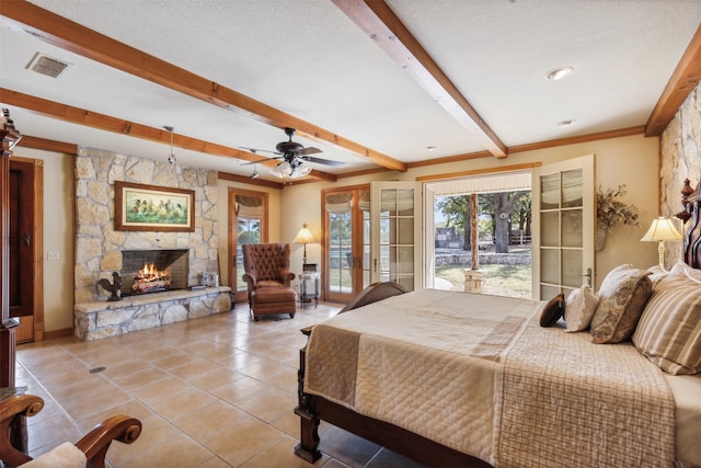 bedroom featuring ceiling fan, access to exterior, beamed ceiling, a fireplace, and french doors