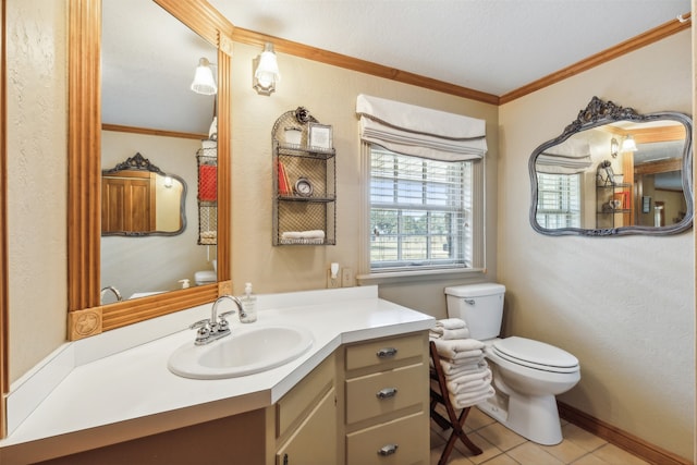 bathroom with vanity, toilet, crown molding, and tile patterned floors