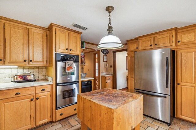 kitchen featuring a center island, stainless steel appliances, hanging light fixtures, and backsplash