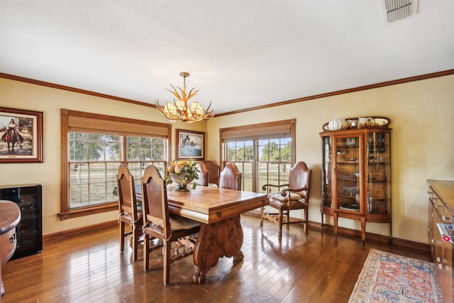 dining space with a notable chandelier, ornamental molding, and dark wood-type flooring