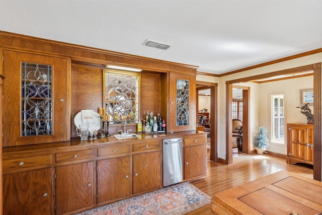 bar with ornamental molding, sink, and light hardwood / wood-style floors