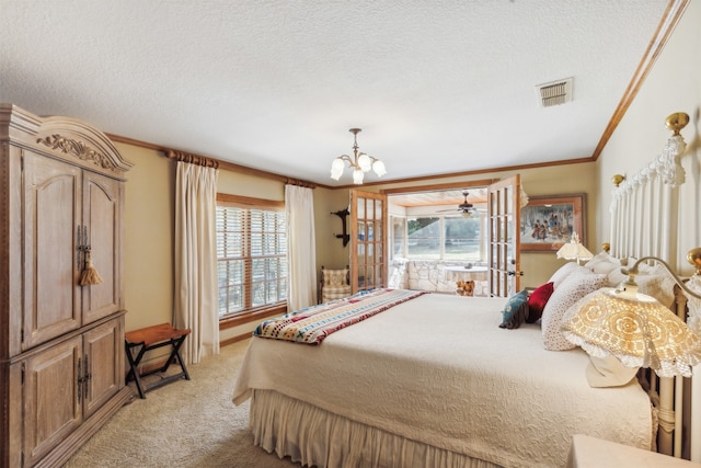 carpeted bedroom featuring crown molding, a textured ceiling, and an inviting chandelier