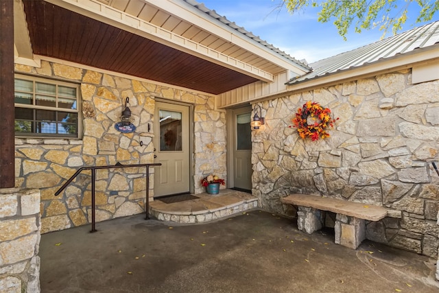 view of exterior entry featuring a patio