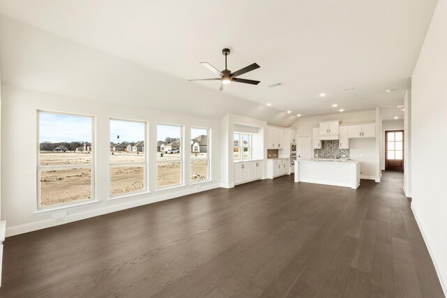 sunroom with plenty of natural light and vaulted ceiling