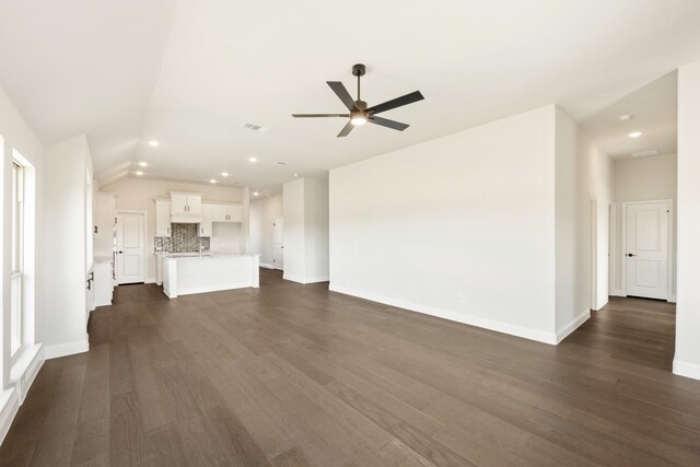 living room featuring ceiling fan and vaulted ceiling