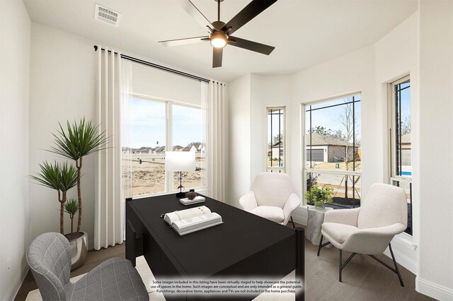 kitchen with ceiling fan, white cabinetry, dishwasher, sink, and an island with sink