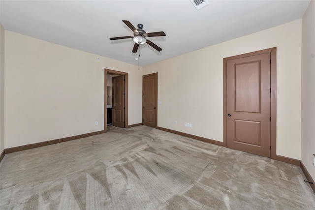 carpeted empty room featuring ceiling fan